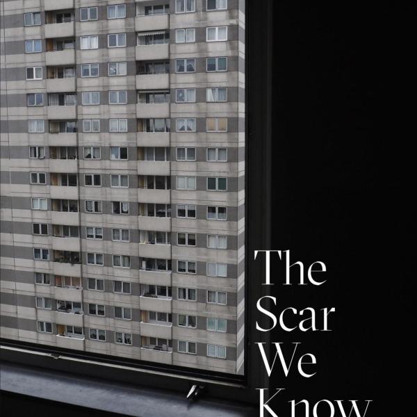 bookcover, looking out window at concrete high rise.