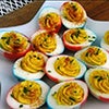 Deviled eggs dyed red, white and blue on a star shaped platter