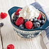 Small cup of berries and whipped cream