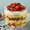 Trifle layered with whipped cream, cake, and berries