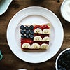 Toast with jam, cream cheese, bananas and blueberries