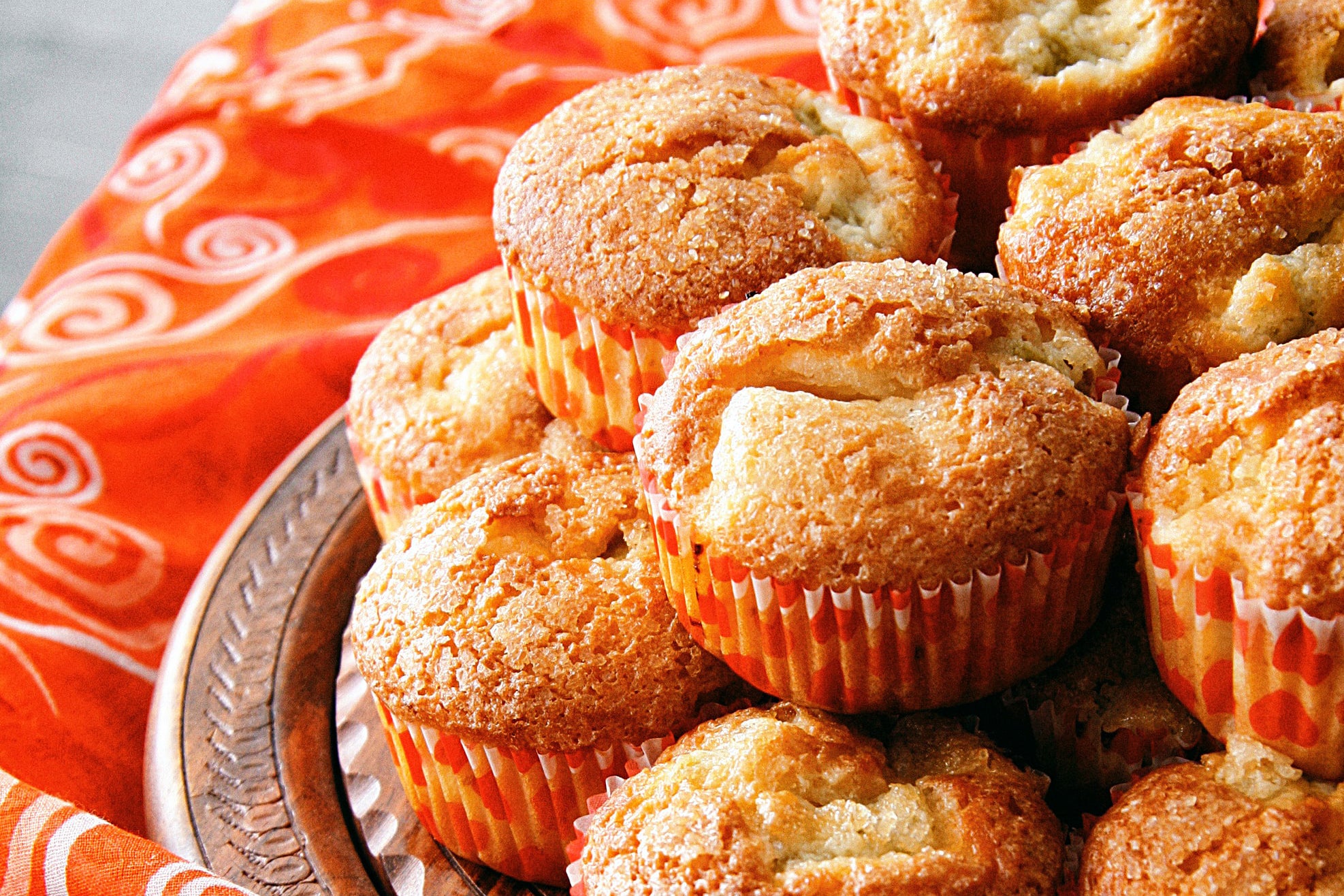 Plate of muffins with a festive table cloth.