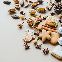 Photo of gingerbread ornaments and pine cones.