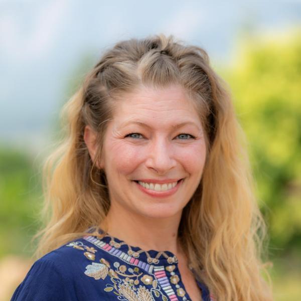 smiling woman in colorful floral top