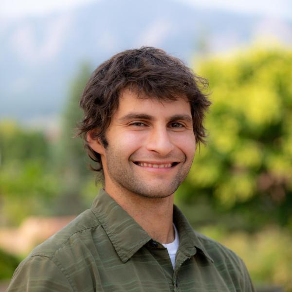smiling man in a green shirt