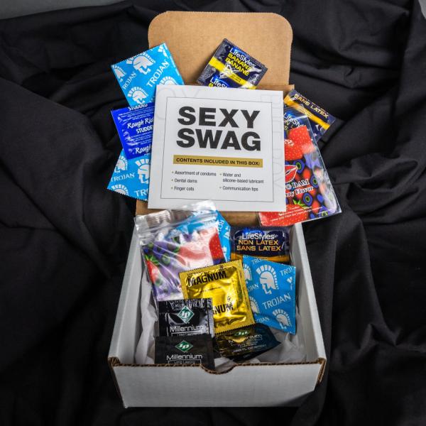 Box with safer sex supplies laid out around it