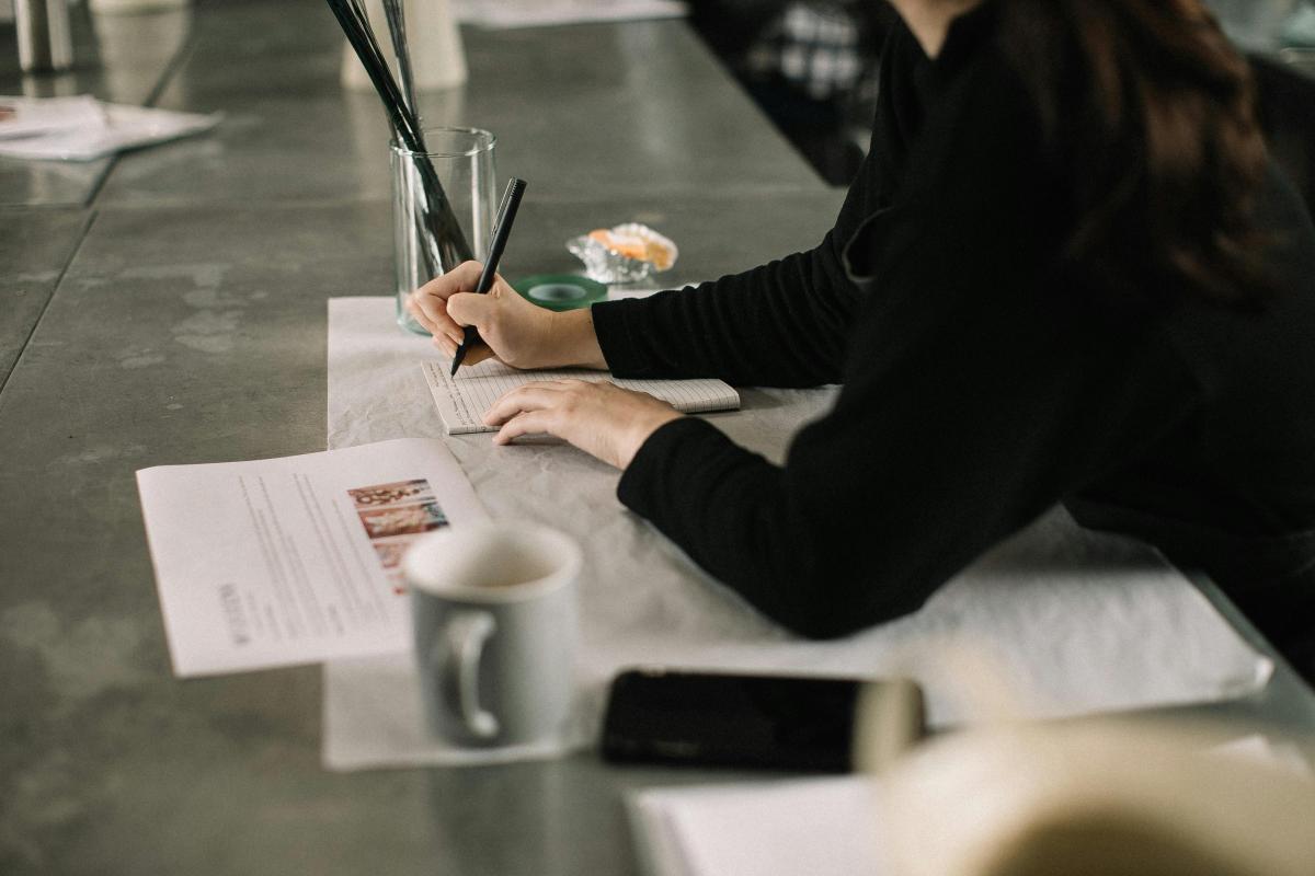 person writing on paper
