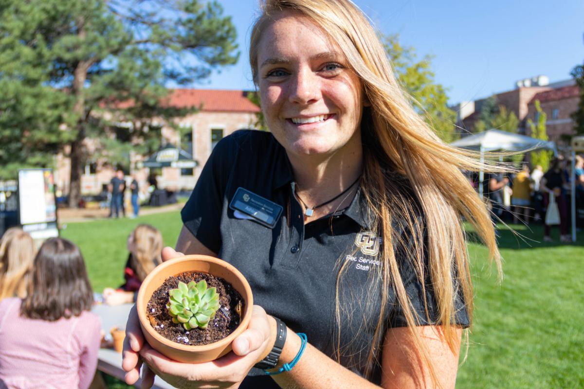 student holding small plant