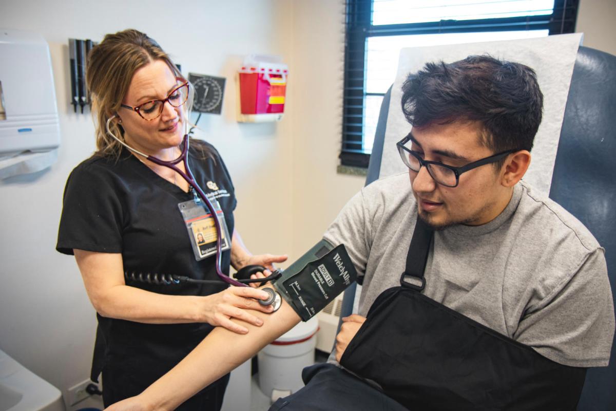 student having blood pressure taken