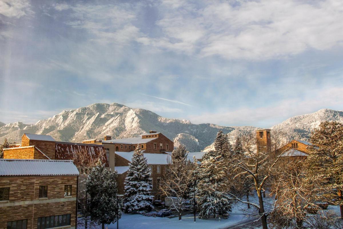 building in front of a snowy mountainscape