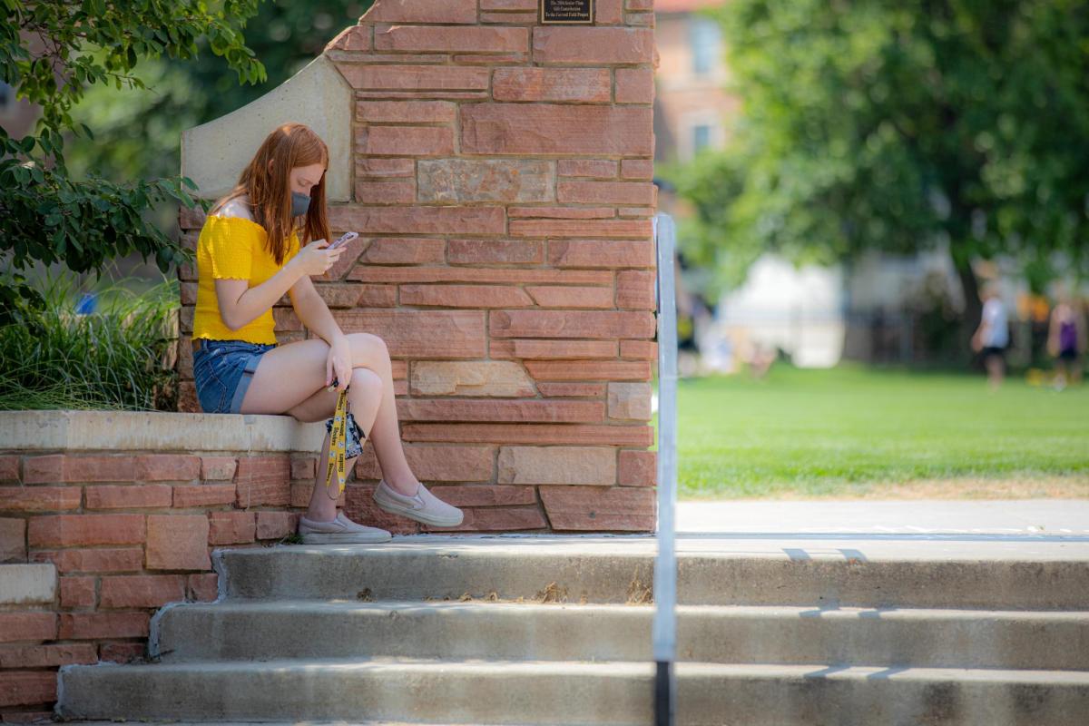 girl alone typing on her phone