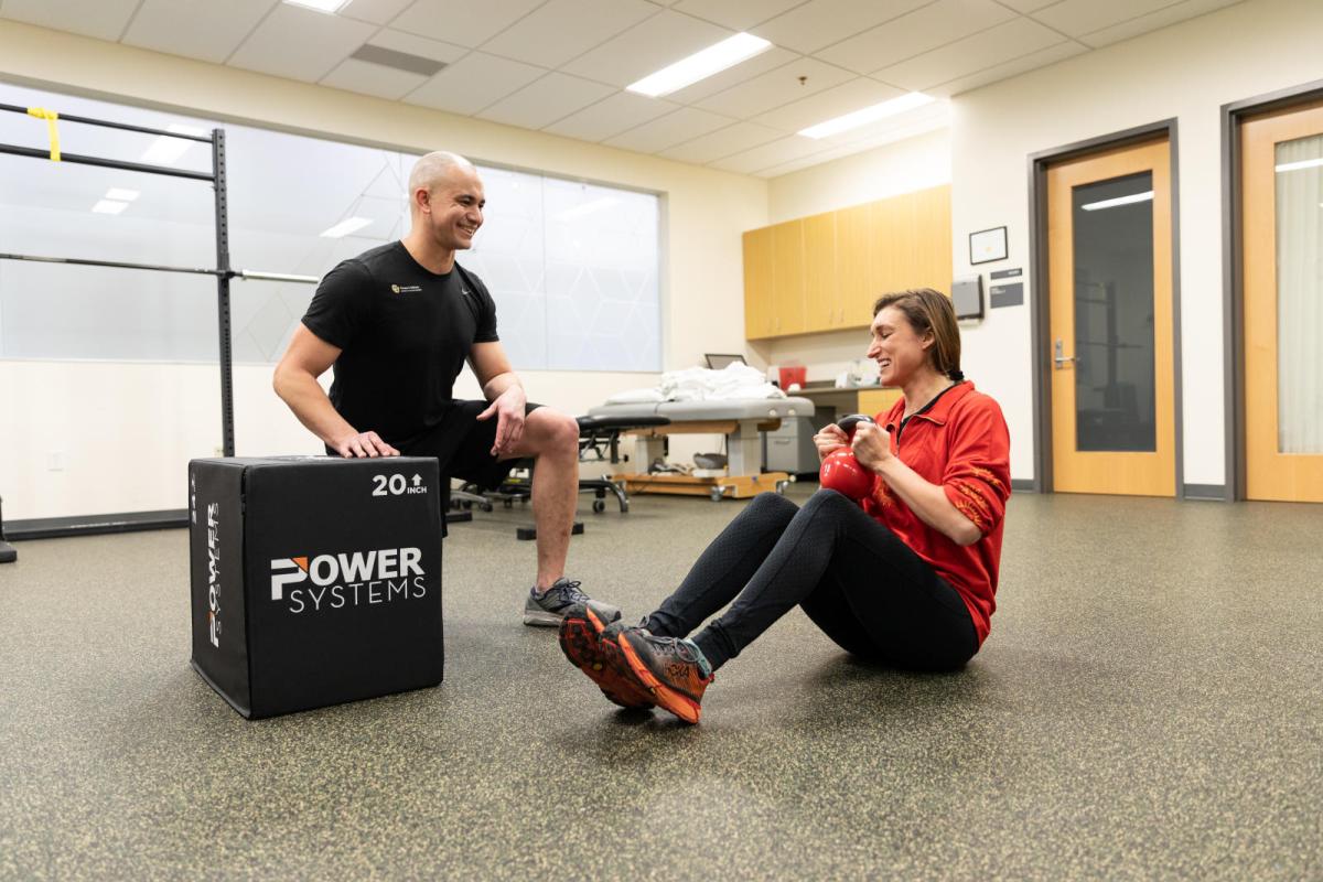 student working with personal trainer