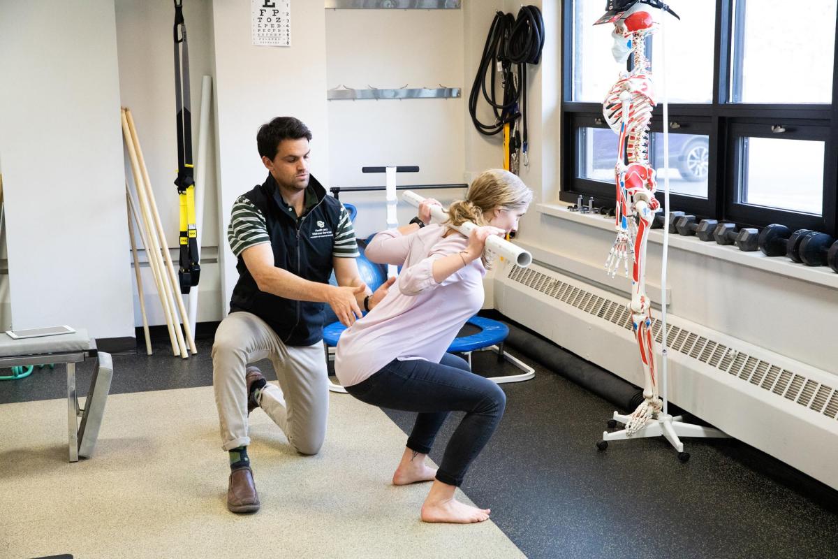 student working with physical therapist