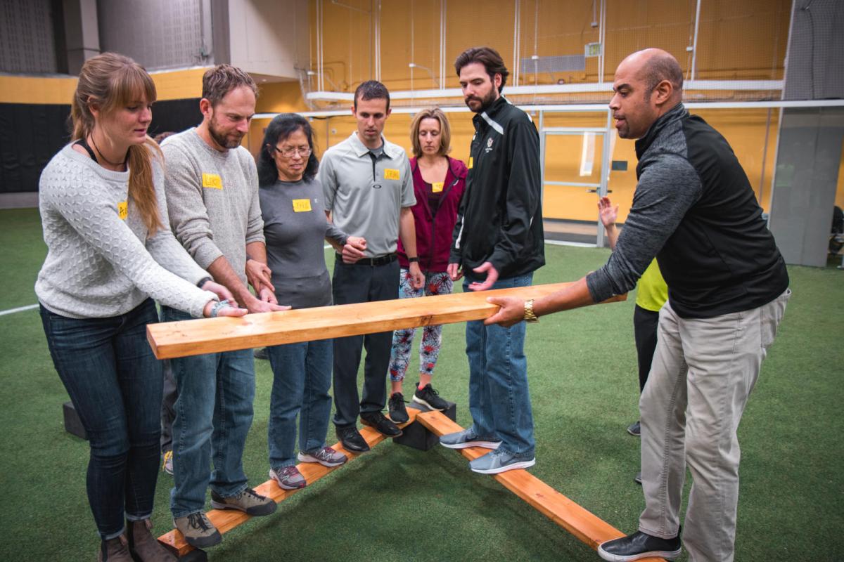 Photo of staff members participating in the challenge course experience at the rec center.