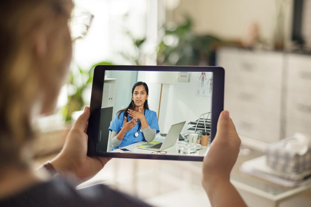 Photo of a person meeting with a provider on their iPad.