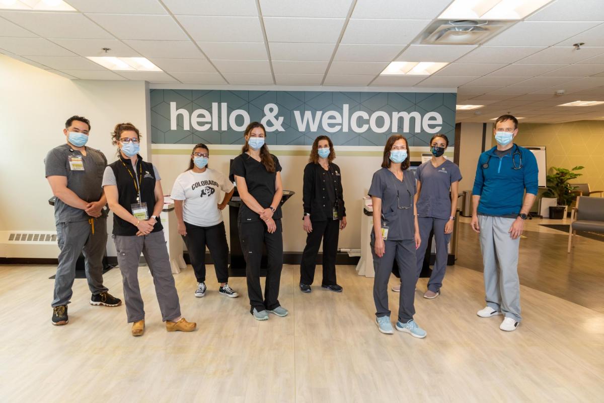Wardenburg staff in a line wearing a mask