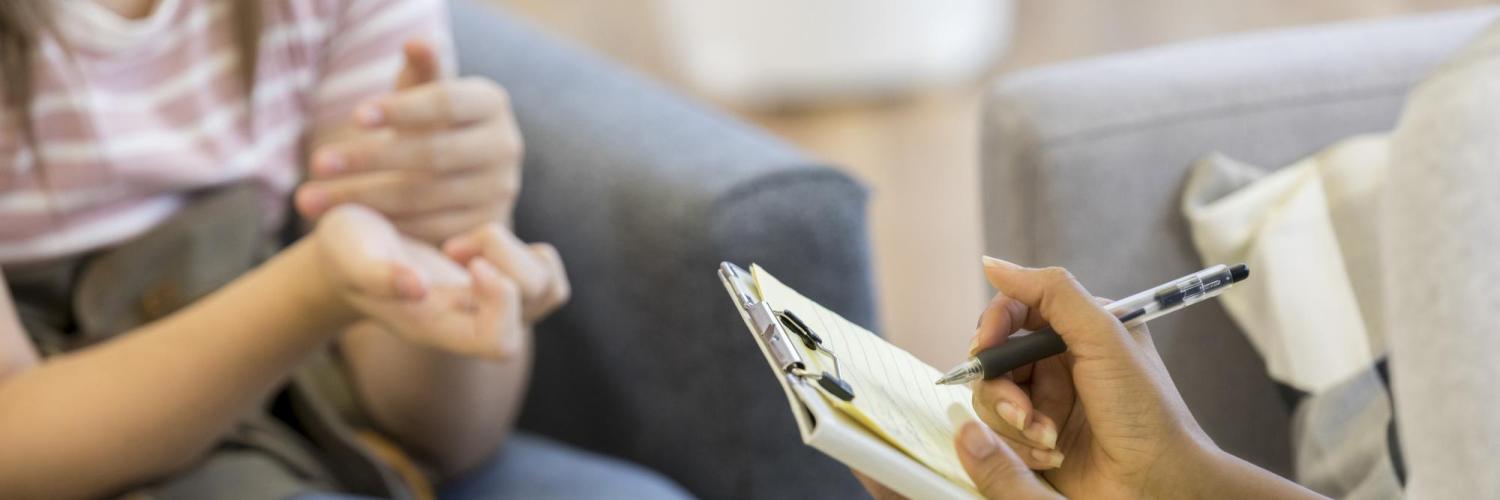 Person talking to counselor taking notes