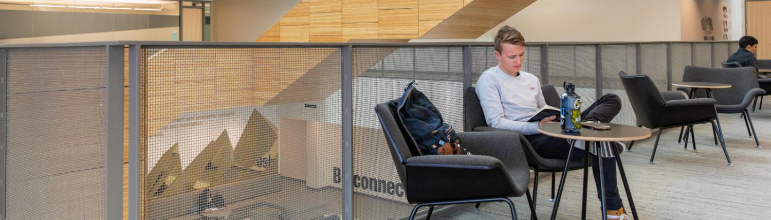 Male student studying in the case building