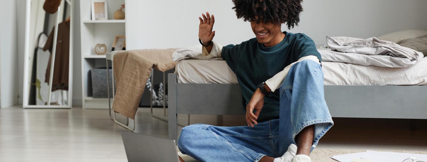 Student on floor talking into computer