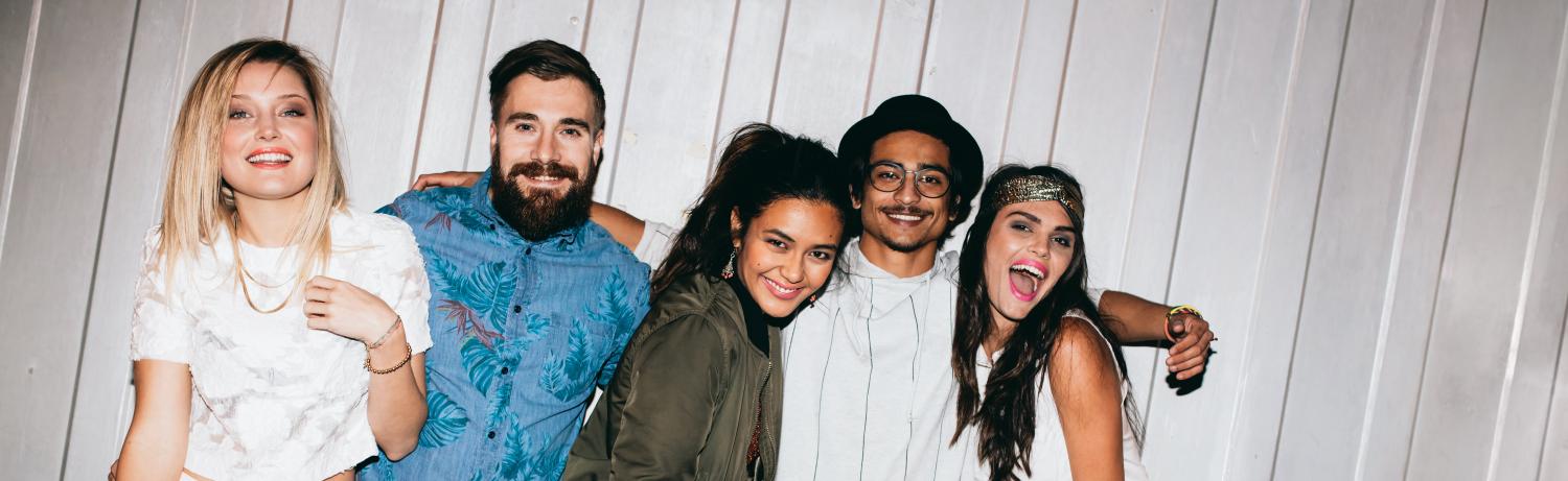 Photo of a group of students posing for a picture with the flash on.