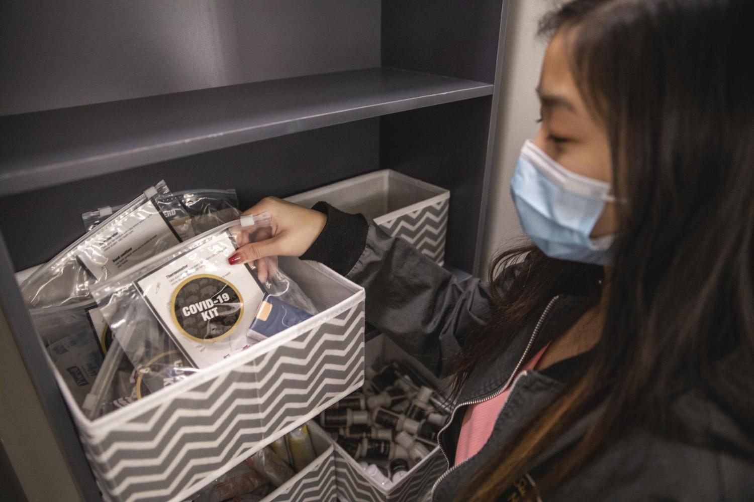 student taking a bag of supplies