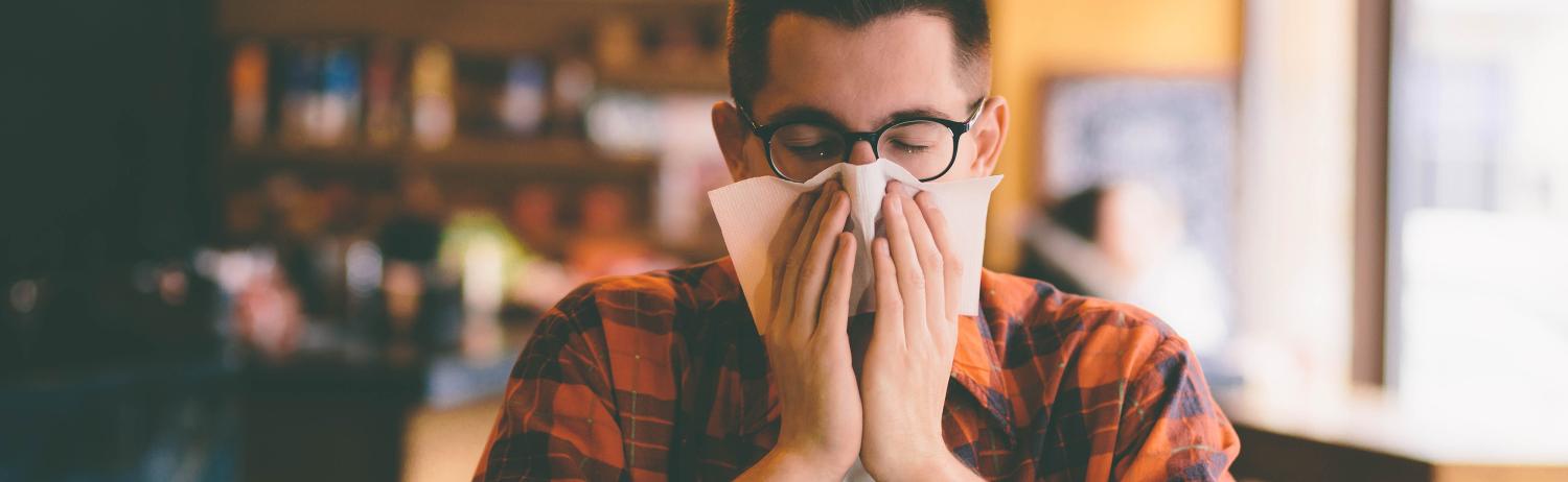 man blowing nose