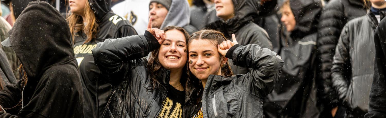 two students at football game