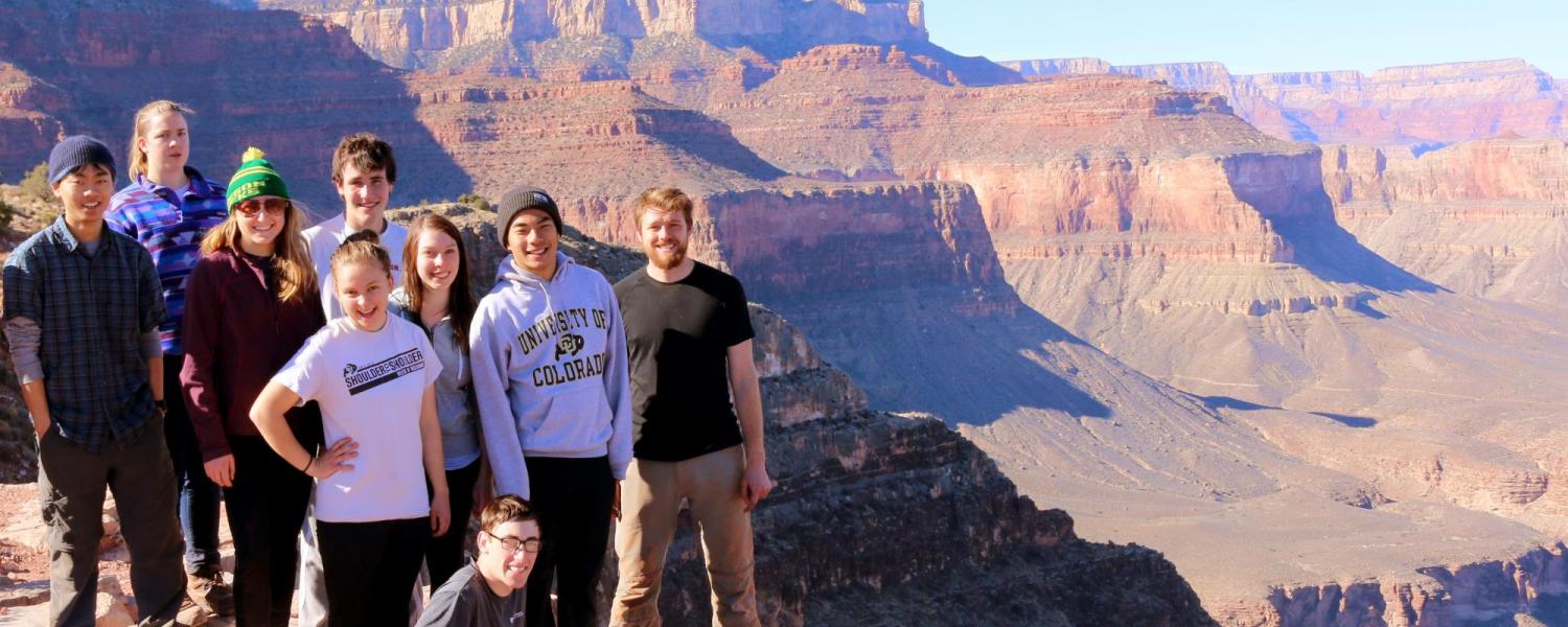 Students posing in front of rock formation in Moab.