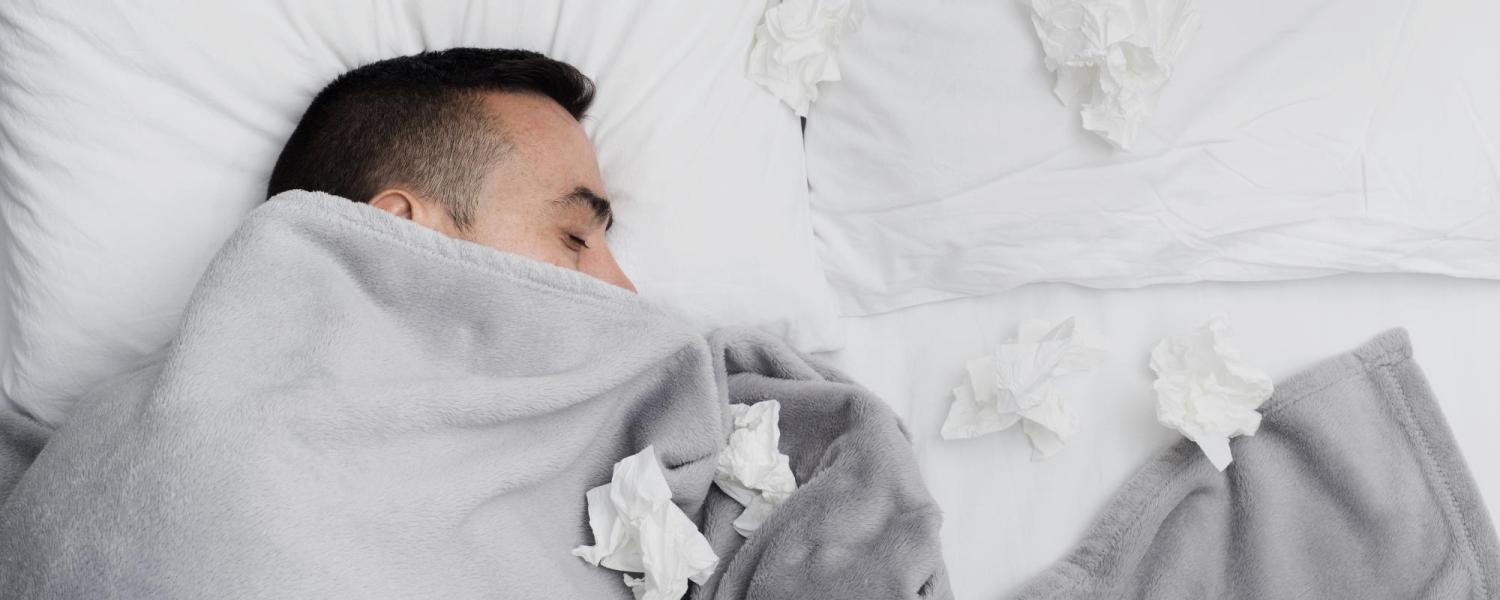 Man in bed with tissues