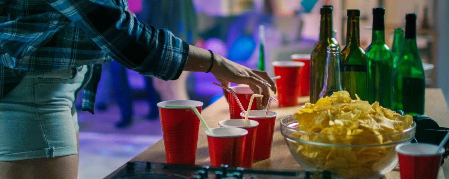 Girl grabbing a solo cup off a table at a party