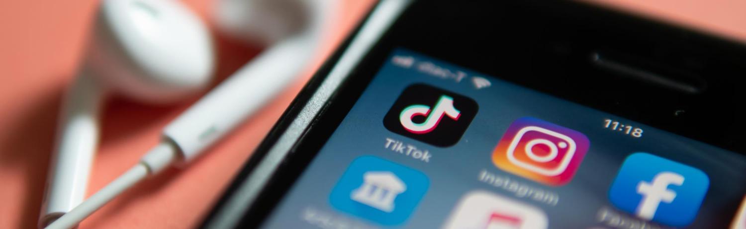 iPhone screen with social media app icons like TikTok, Instagram and Facebook