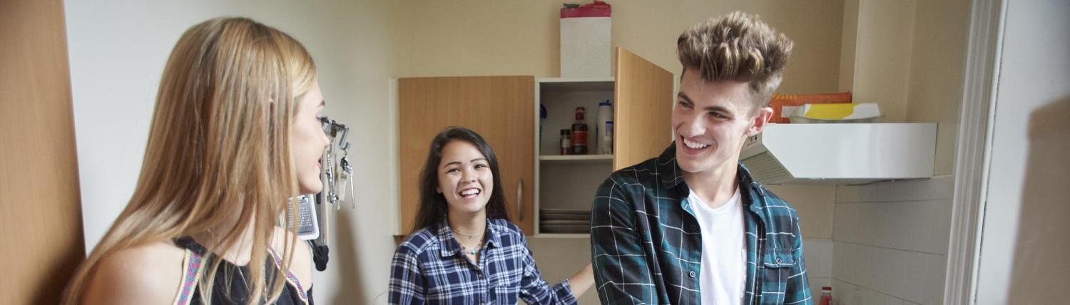 Roommates talking in a small kitchen