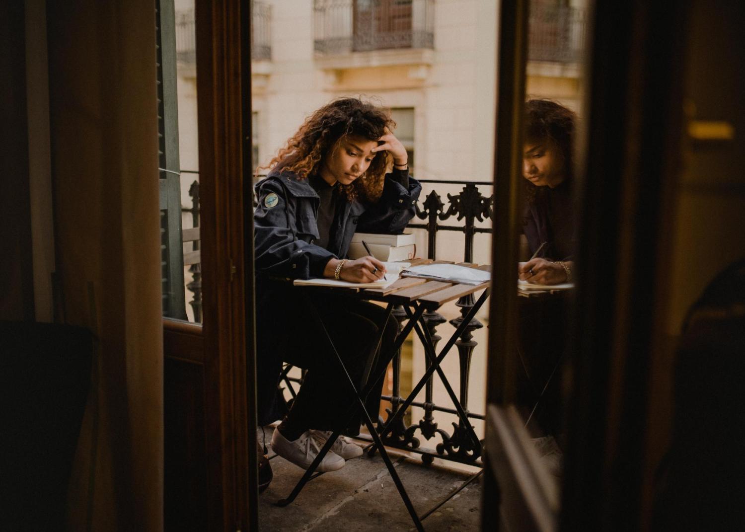 Woman with books writing