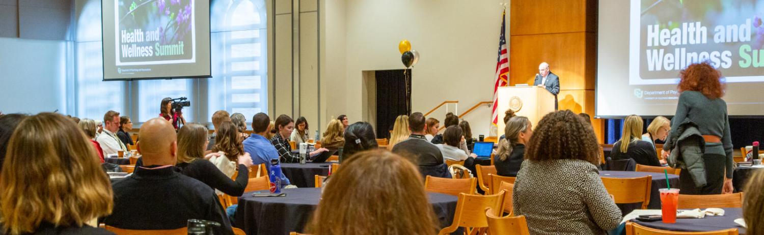 Photo of staff and faculty attending a large presentation at the UMC as part of the Health and Wellness Summit.