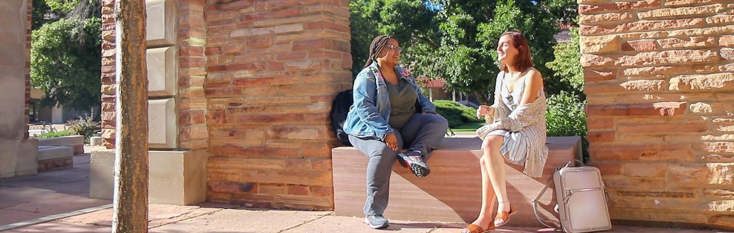 two students outside on a sunny day