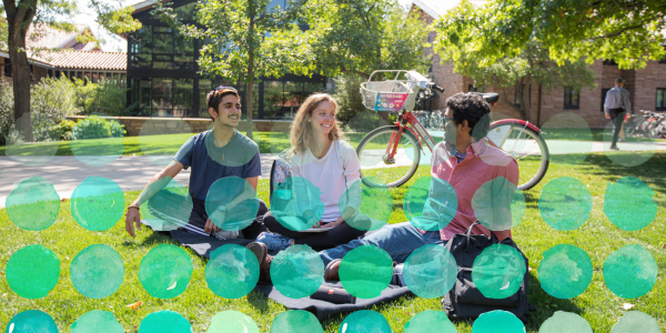 Photo of a friend group sitting outside.