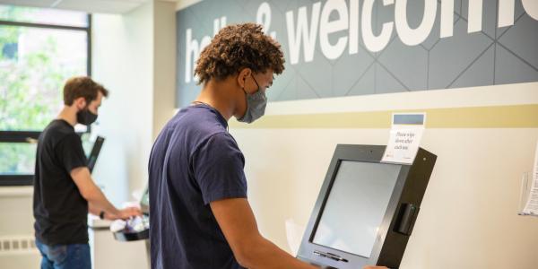 Photo of students checking in at Wardenburg Health Center.