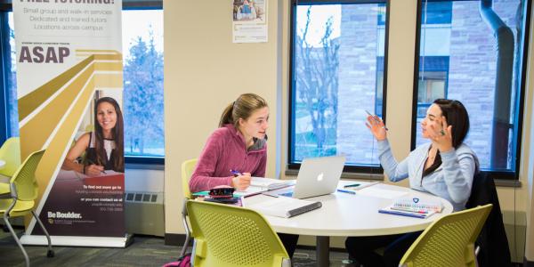 Photo of a student meeting with an ASAP tutor for help on an assignment.