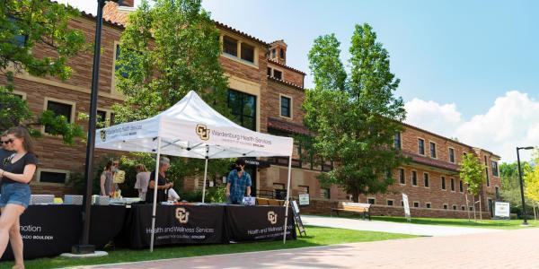 Tabling event happening in front of Wardenburg Health Center on campus.