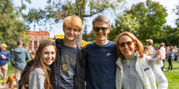 Photo of a family posing with their Buff student.