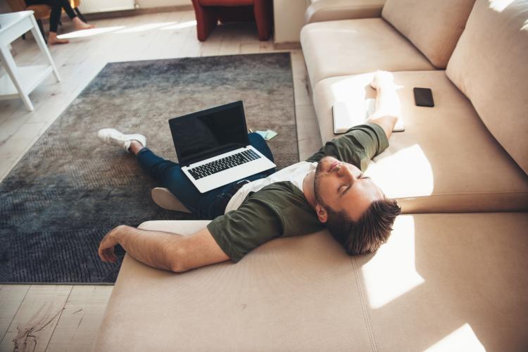 man sleeping with computer