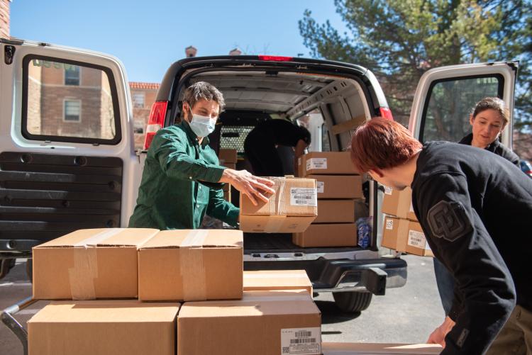 people unloading boxes from a truck