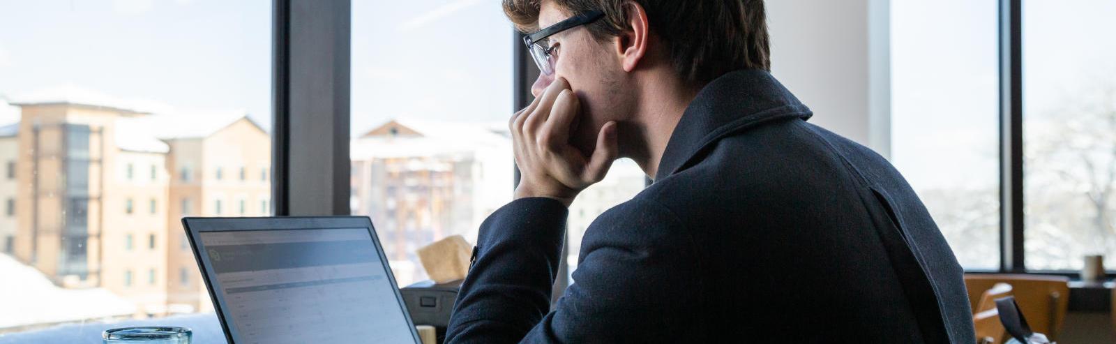 A person sitting looking at a computer