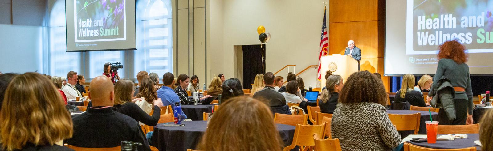 Photo of staff and faculty attending a large presentation at the UMC as part of the Health and Wellness Summit.