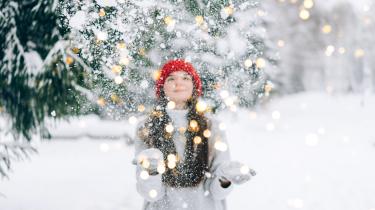 girl outside in the snow with lights