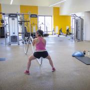 Female student using ropes in the functional fitness area