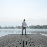 man standing by a lake reflecting on his life