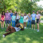 Photo of a group of students posing with Chip the Buffalo on Farrand Field.