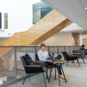 Male student studying in the case building