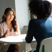 Photo of a student meeting with a mental health provider to ask questions about therapy.